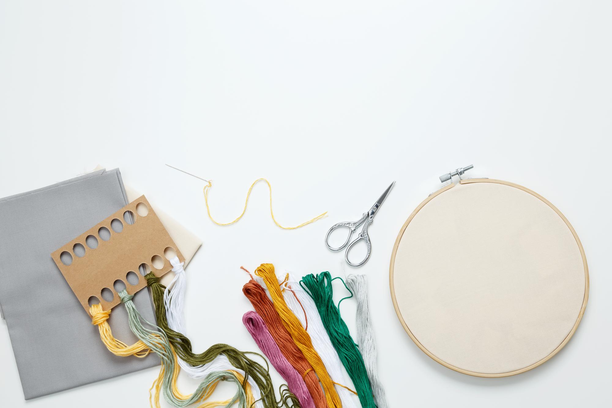 Flat lay of embroidery kit and tablet